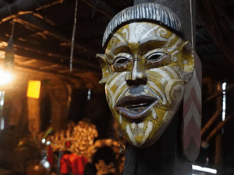 traditional wooden face mask hang on the pillar